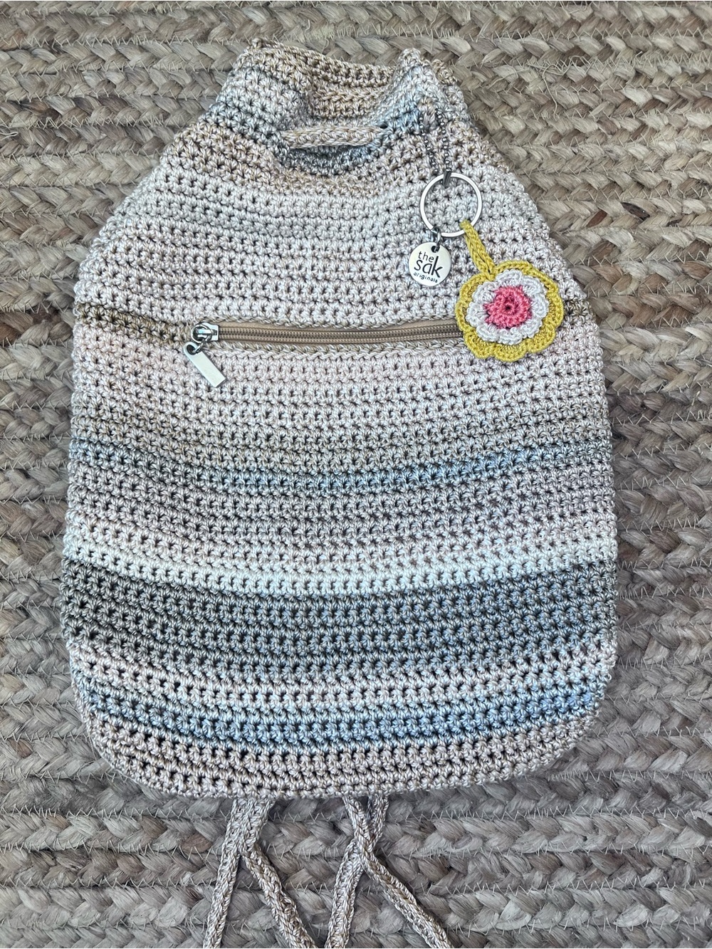 The Sak Crochet Drawstring Bucket Bag in Beige and Gray